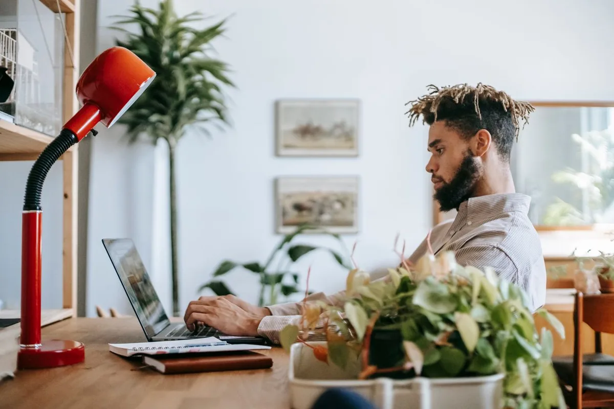 Illustrative photo: freelancer working on a laptop in a bright home office